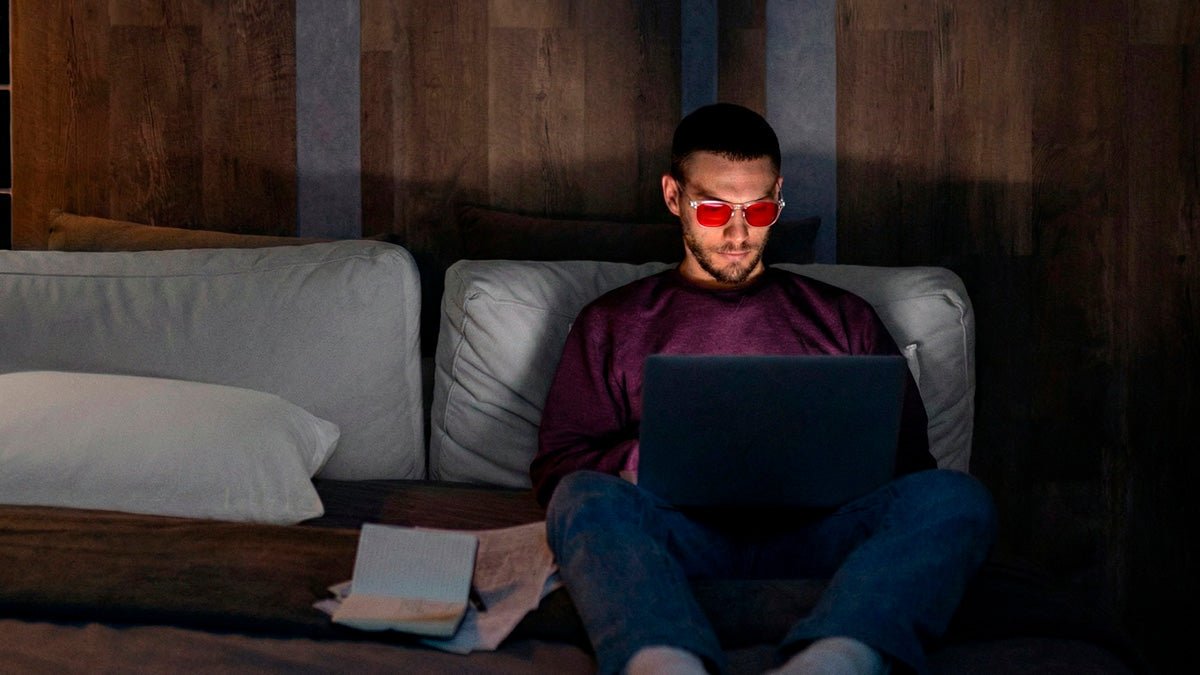 Persona usando gafas de luz azul frente a una pantalla en interior